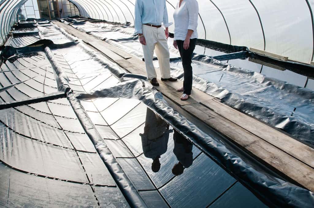 Artisanal salt makers standing among the salt drying beds